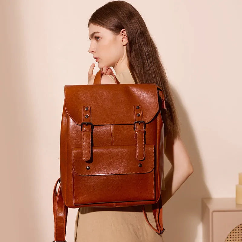 Black cowhide leather laptop backpack for women with a structured, hard-sided design.