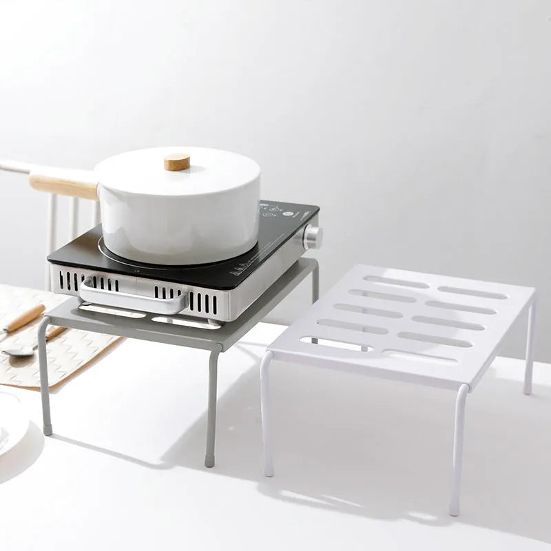 Retractable ABS rack with hollow grid design for kitchen, living room, or bathroom storage, available in grey or white