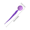 Green bouncy worm-shaped cat toy with a long plush tail on a wooden floor.