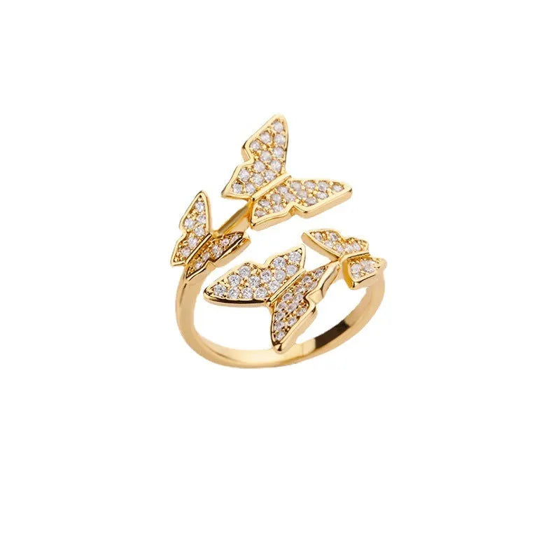 Personality zircon butterfly ring with three-dimensional design in gold tone on a white background