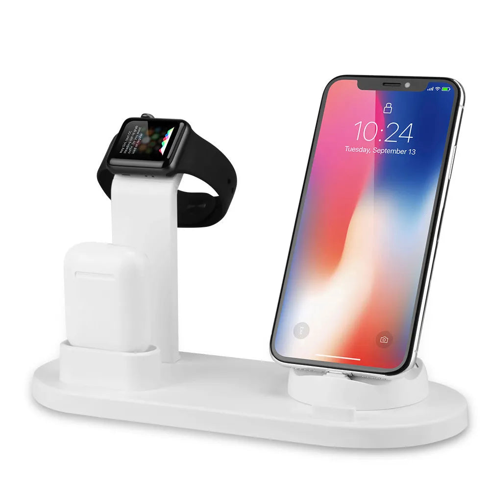 White aluminium wireless charging stand holding phone, headphones and smartwatch