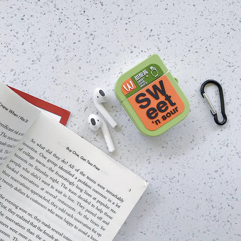 Green silicone AirPods 1/2 generation case with a cartoon animal design on a table.