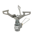 Compact portable gas camping stove with one-piece cast iron burner on a green background.