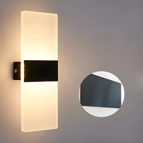 Modern acrylic wall-mounted LED bedside lamp in silver finish showing warm light illumination