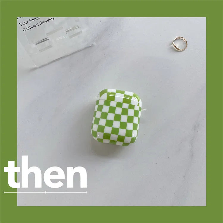 Black and green checkerboard patterned TPU protective case for Apple AirPods with optional lanyard and loop pendant attachments.