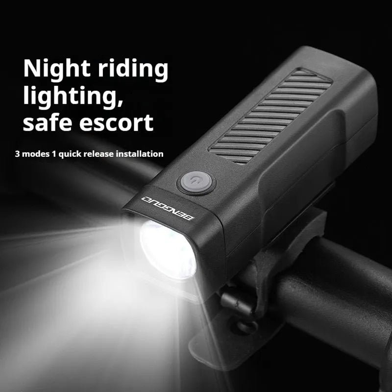 Black USB rechargeable bicycle headlight with quick-release strap mounted on bike handlebars.