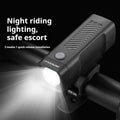 Black USB rechargeable bicycle headlight with quick-release strap mounted on bike handlebars.