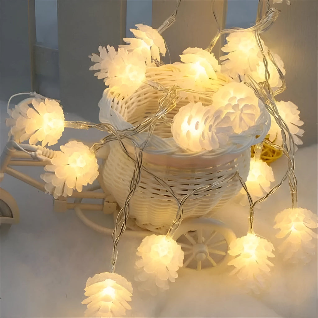 Warm white LED pine cone fairy lights on a string, battery-powered for indoor and outdoor decorative use.
