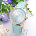 Retro GENEVA three eye quartz watch with leather belt displayed on a table