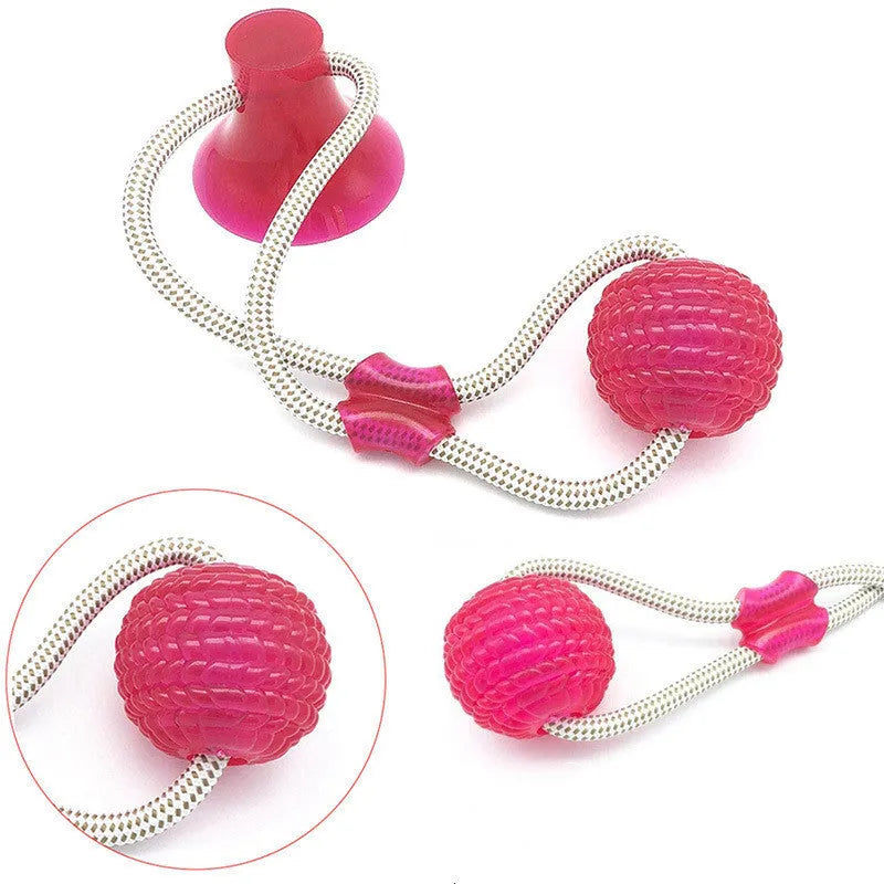 Pet dog rubber sucker molar toy in red colour on smooth surface