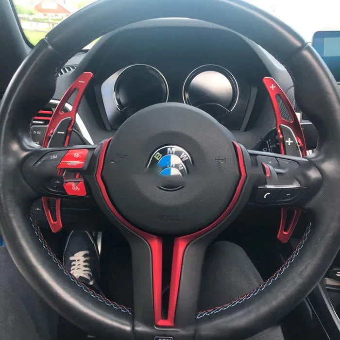 Pair of aluminium alloy paddle shift extenders for BMW M models on a black background