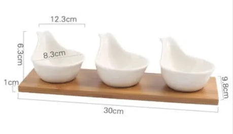 Porcelain ceramic dried fruit dish with compartments on wooden serving board
