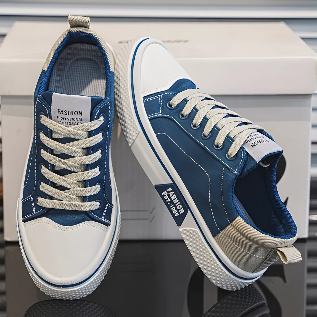 Men's low-top canvas shoes in blue with white sole and lace-up front, on a grey background.