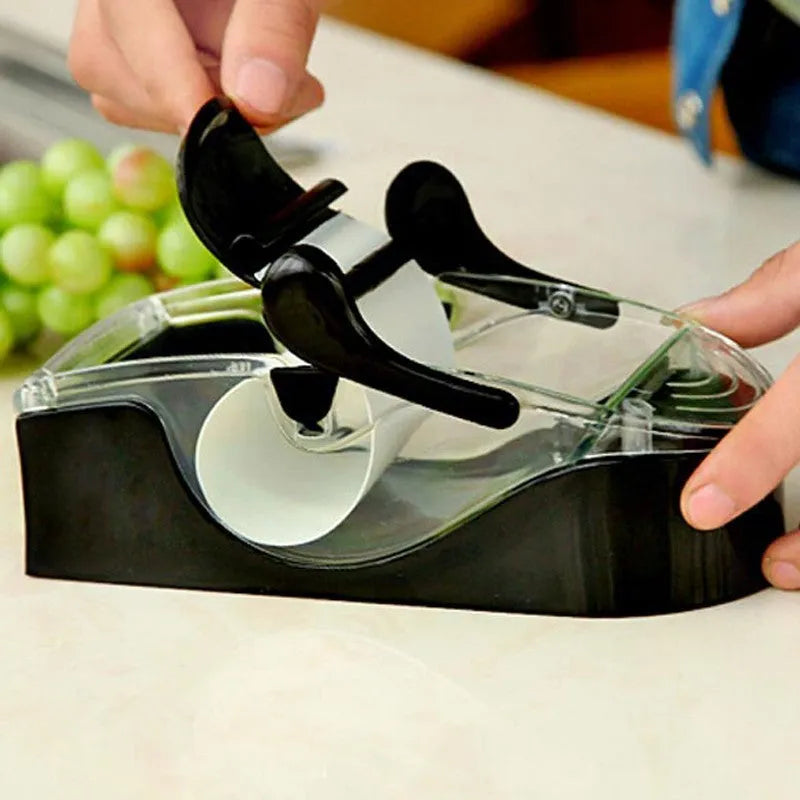 Black DIY plastic kitchen roll sushi machine on a flat surface with lever and roller band visible