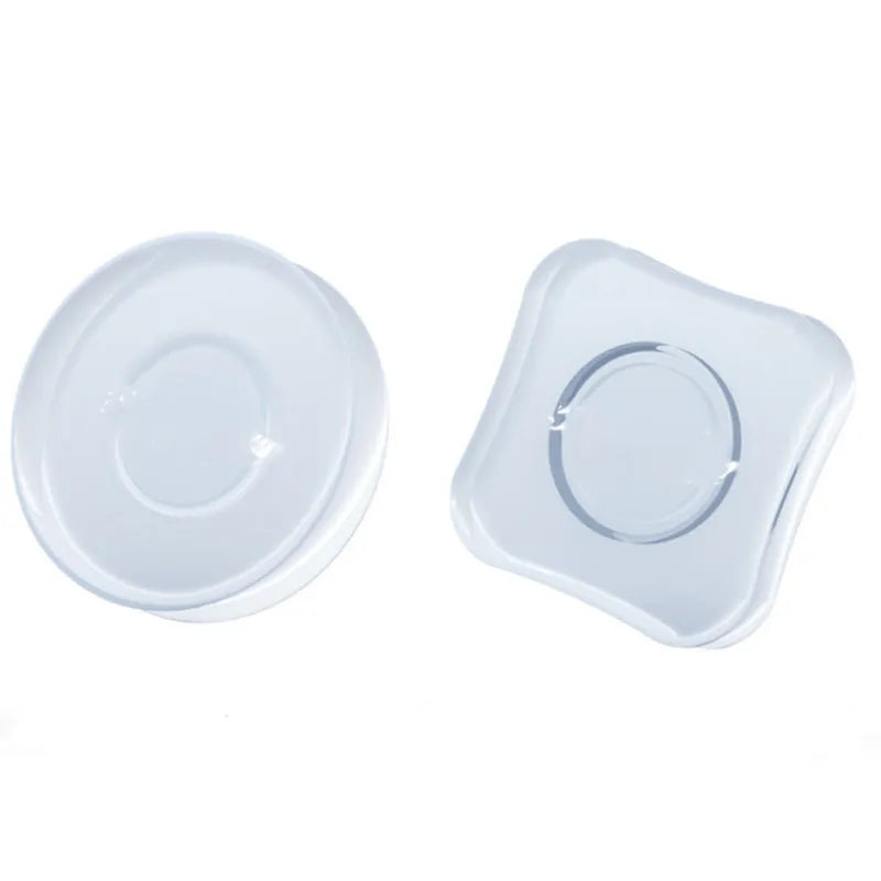 Transparent circular and square silicone nano gel adhesive pads on a car dashboard holding a mobile phone.