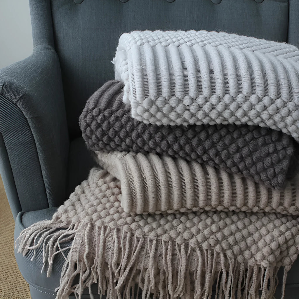 Small grey polyester nap blanket folded, showing its 127cm by 170cm size.