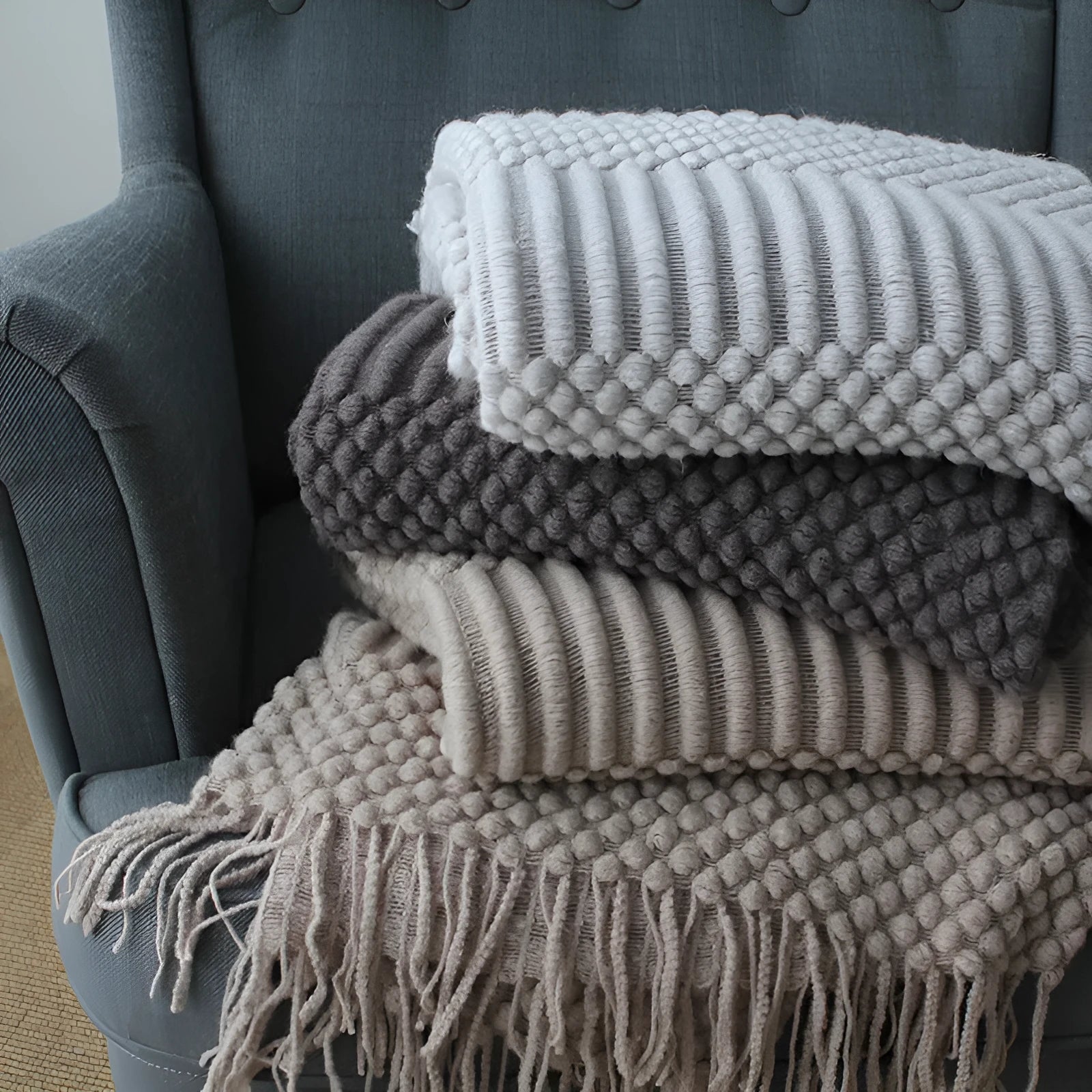 Small grey polyester nap blanket folded, showing its 127cm by 170cm size.