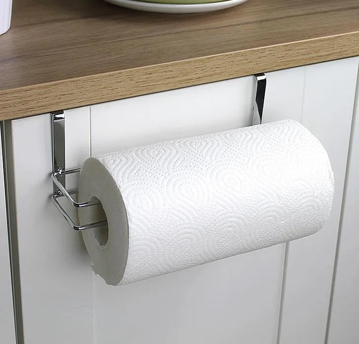 Silver stainless steel kitchen towel rack mounted on a cabinet door holding a paper towel roll.