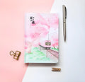 Muco hardcover notebook with sakura flower orbit AR design in pink, green, red, and yellow colour options.