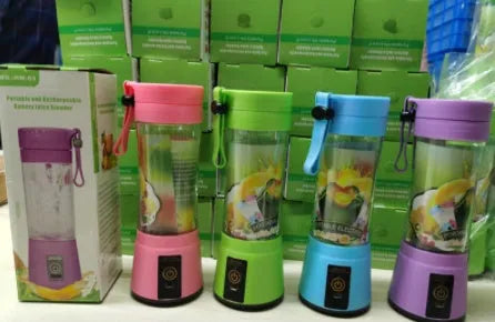 Pink portable USB rechargeable blender with six blades and a 380ml transparent cup on a table.