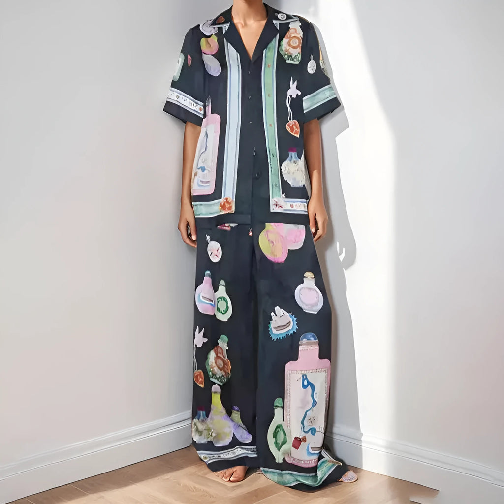 Black women's casual set with cartoon print, featuring a cardigan and matching trousers on a hanger.