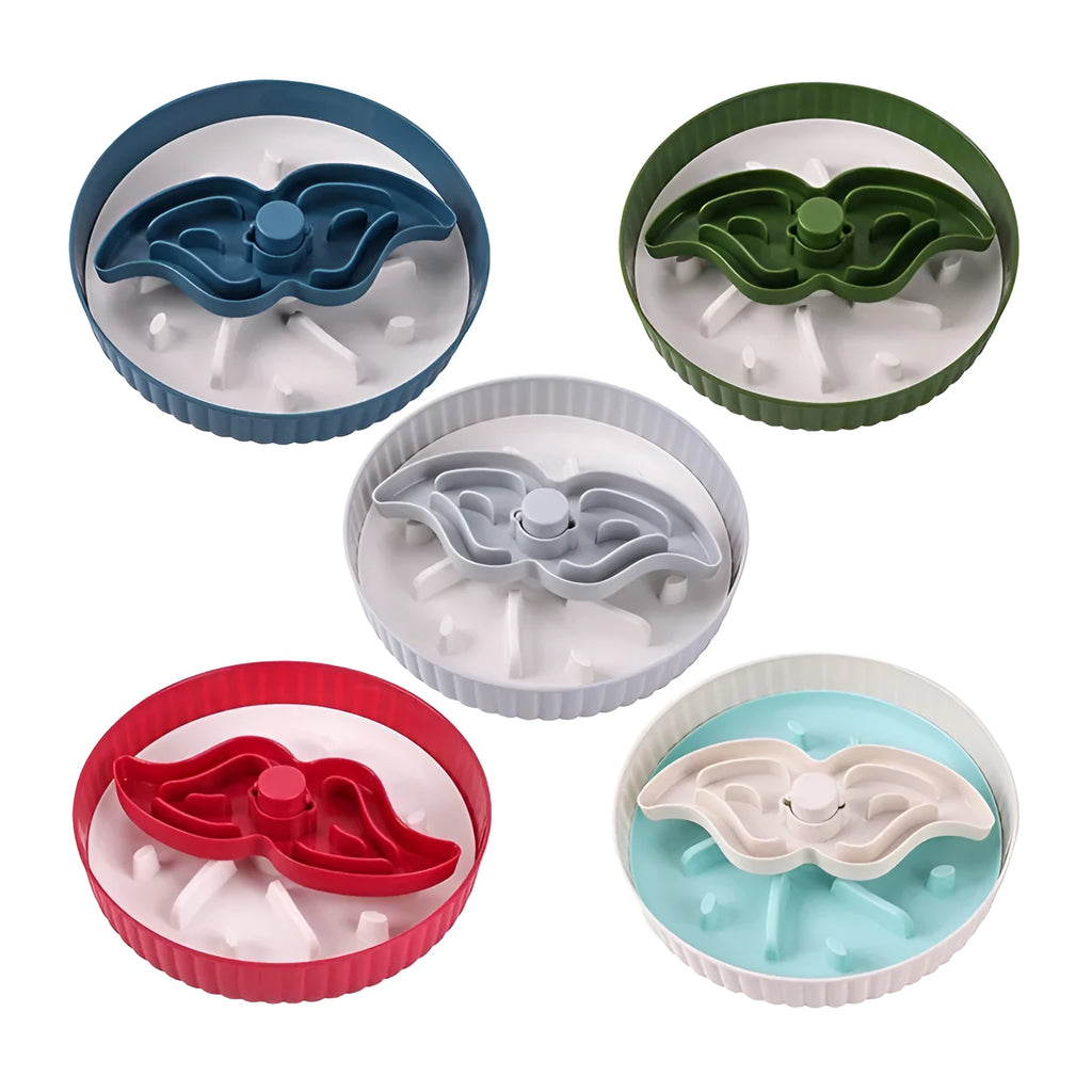 Grey pet bowl with a rotating windmill-pattern silicone licking mat for slow feeding on a kitchen floor.