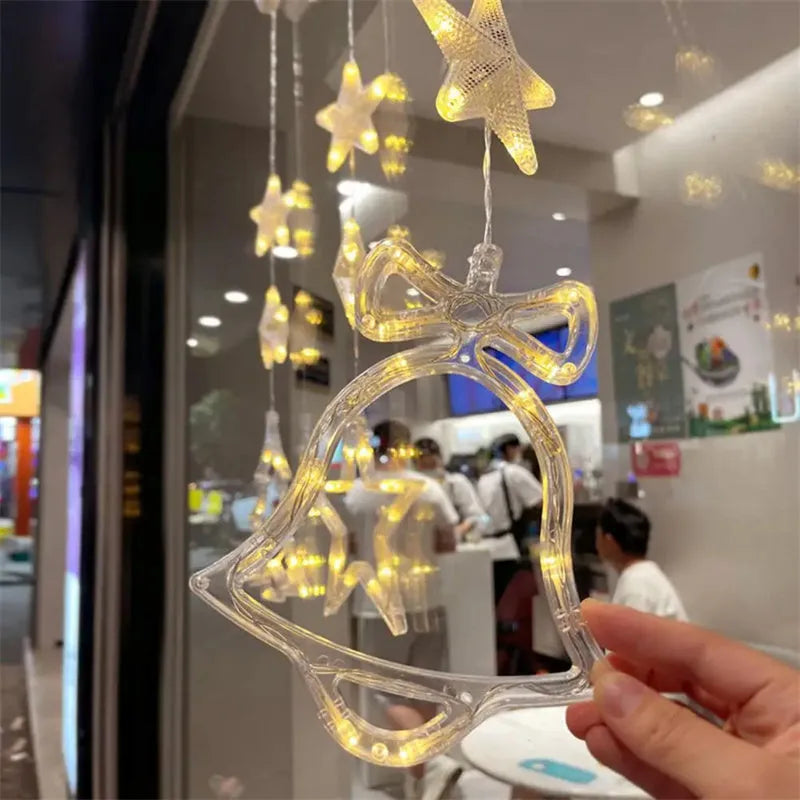 Set of three Christmas LED light pendants with suction cups, showing star, deer, and tree designs on a window.