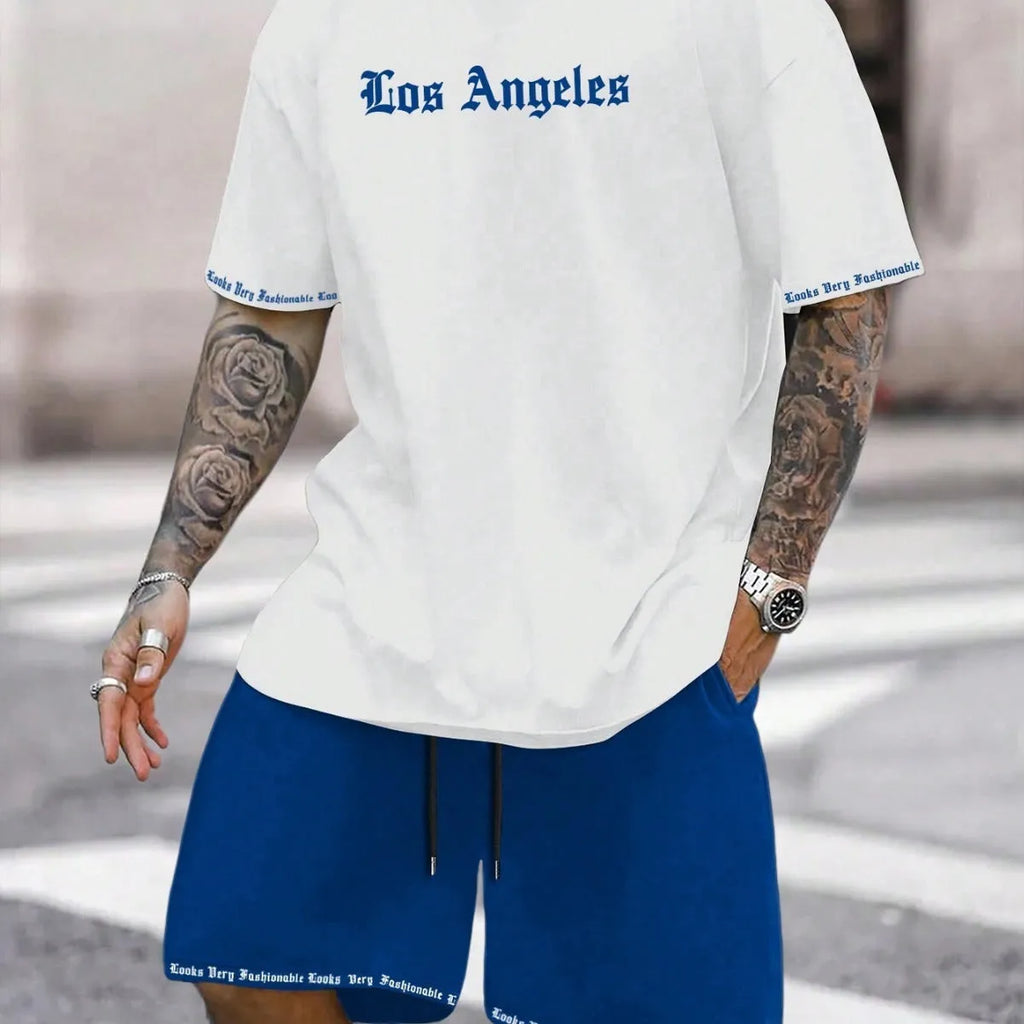Man wearing a printed short-sleeve top and matching shorts from a sports style suit set.