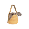 Women's medium beige PU bucket straw bag with open top and messenger strap on neutral background