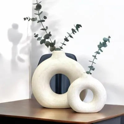 Frosted unglazed porcelain biscuit vase in a simple modern style on a table.