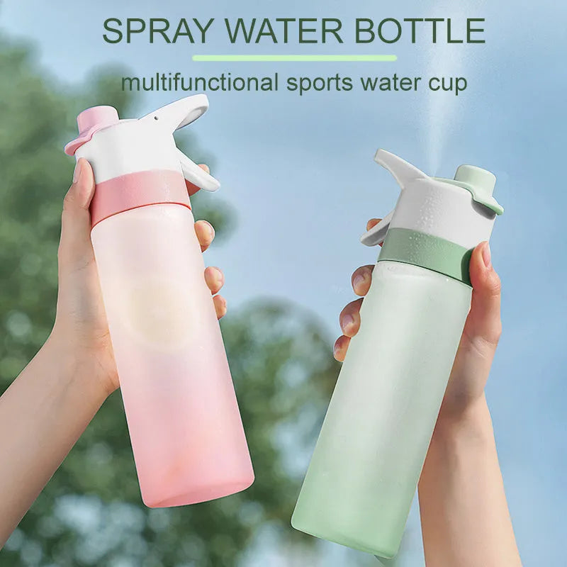 White plastic spray water bottle with handle strap and leakproof lid on a gym bag.