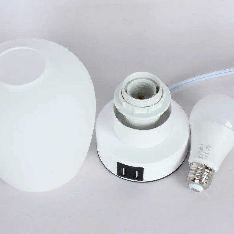 Nordic touch glass desk lamp with three colour modes and USB power on a bedside table