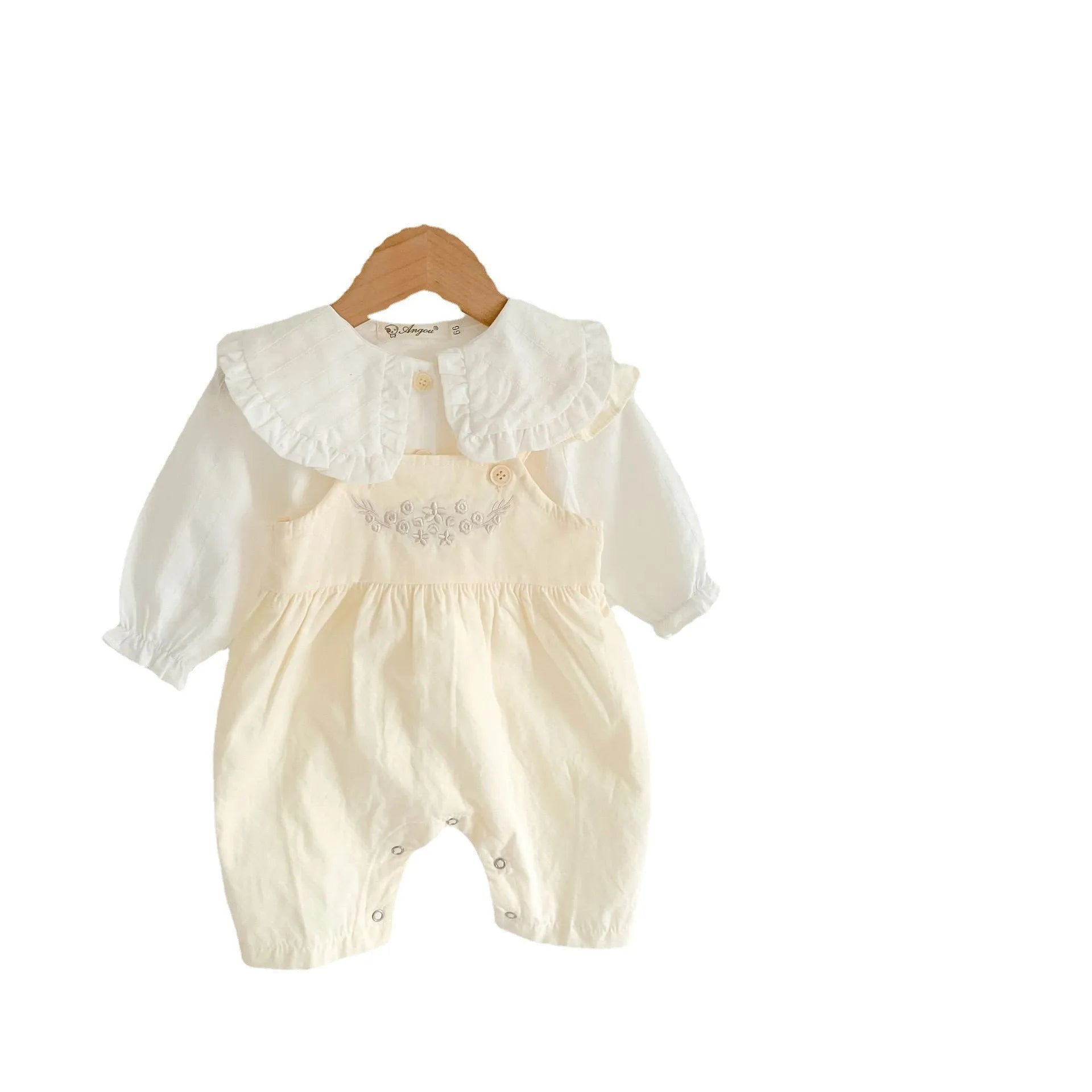 Apricot coloured baby girl's cotton romper with white top, adjustable suspenders, and mid-waist trousers.