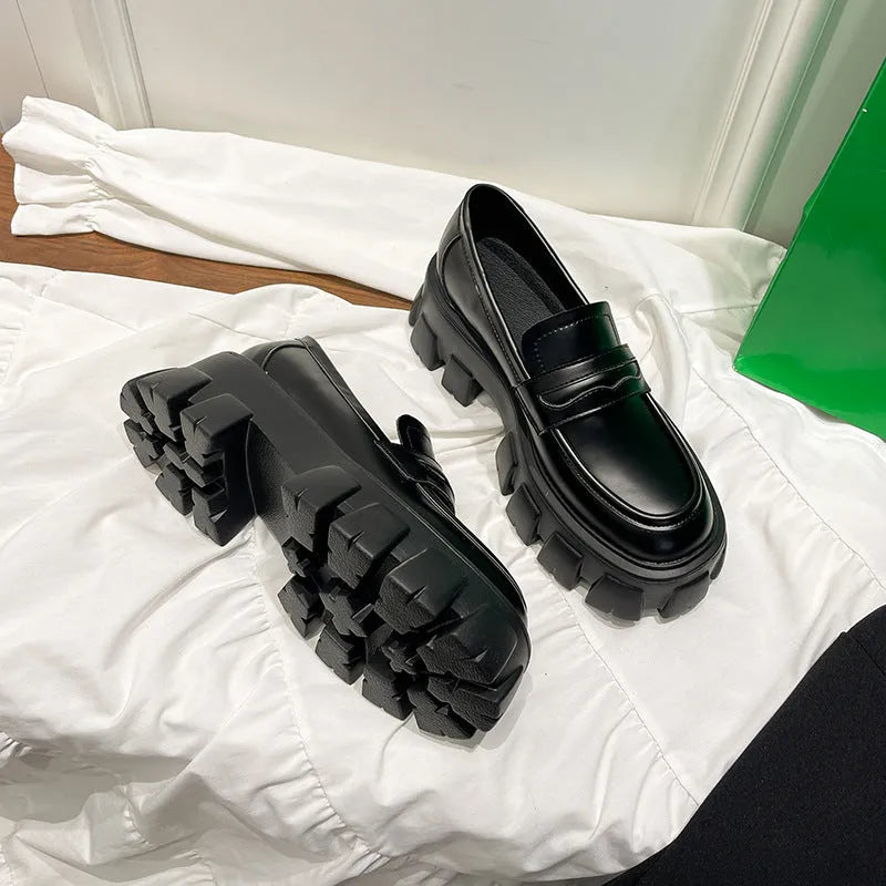 British style wide fit patent leather loafers with a muffin heel and rubber sole.