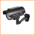 Black gun-style solar dummy camera with flashing red LED light for security deterrent