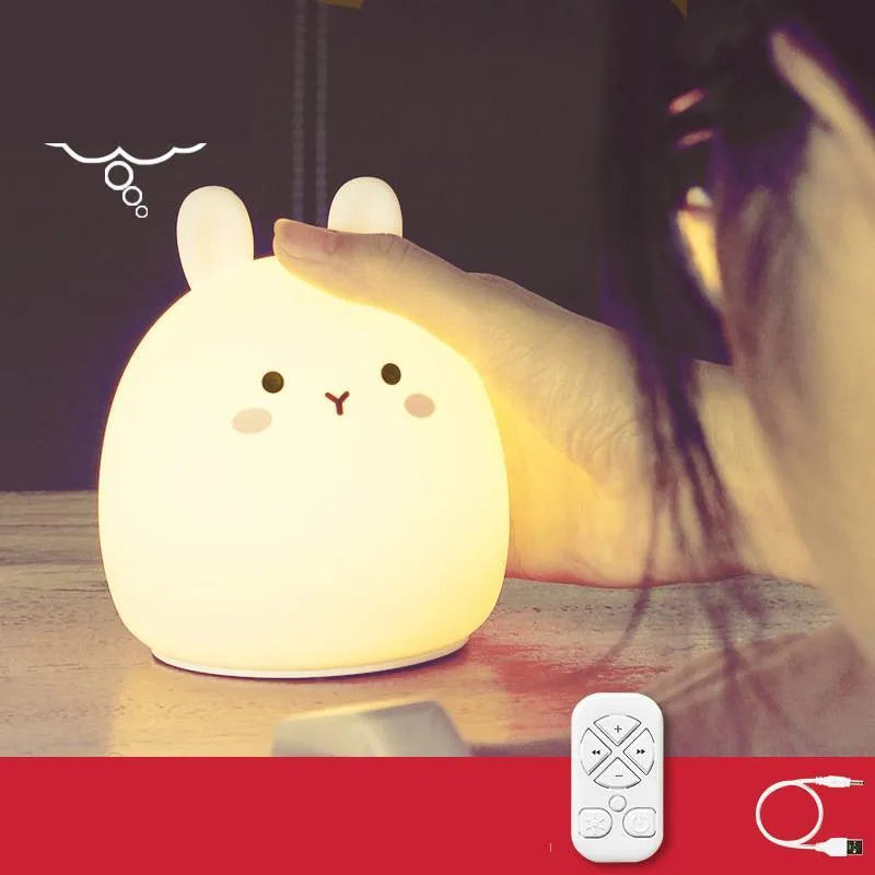 Soft silicone cartoon rabbit rechargeable LED night light on a surface, showing colour change feature.