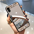 Mirror silver soft shell phone case with rhinestones on a white background