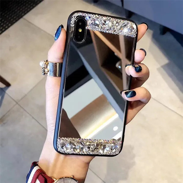 Mirror silver soft shell phone case with rhinestones on a white background