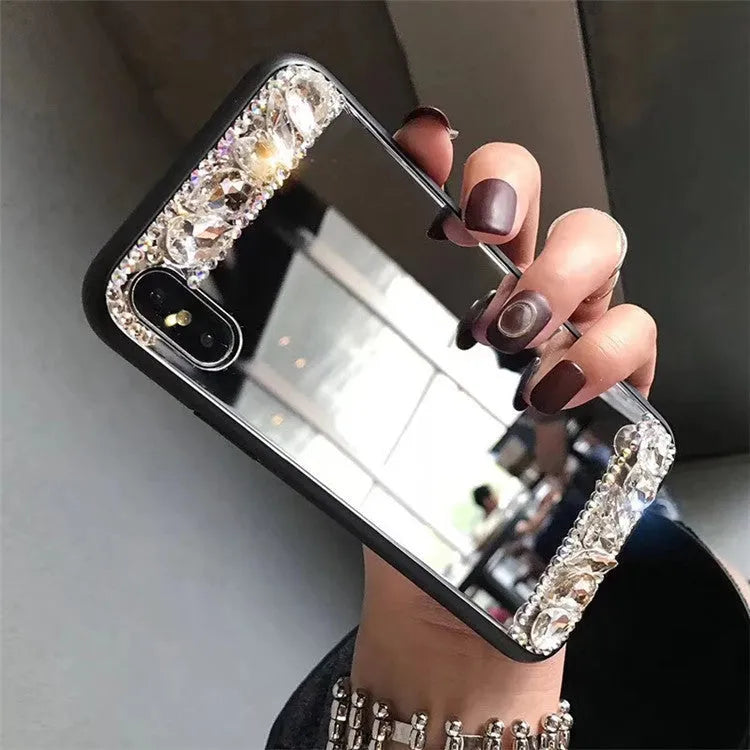 Mirror silver soft shell phone case with rhinestones on a white background