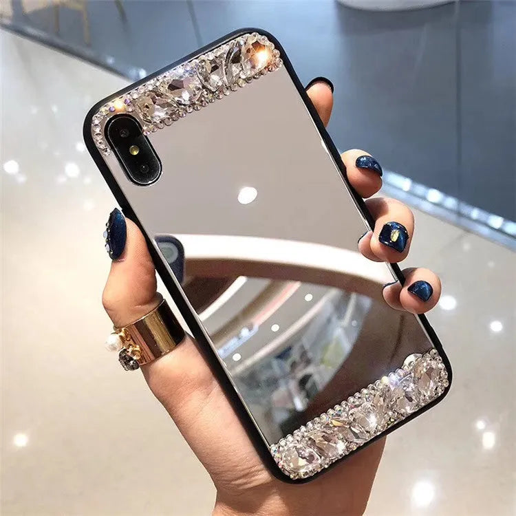 Mirror silver soft shell phone case with rhinestones on a white background