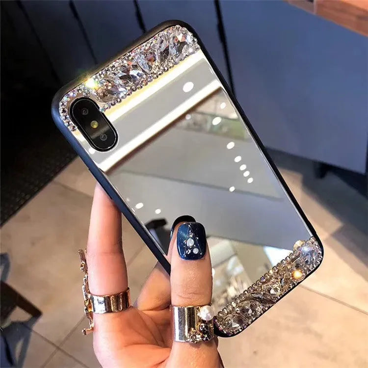 Mirror silver soft shell phone case with rhinestones on a white background