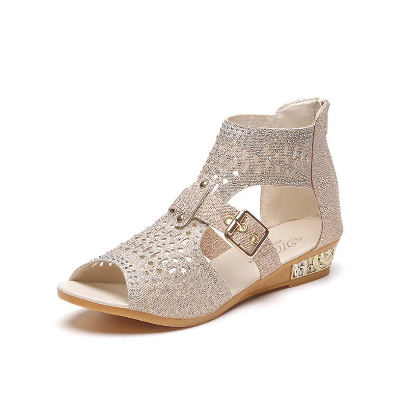 Women's beige flat sandals with a fish mouth toe, back zipper, and a low wedge heel.