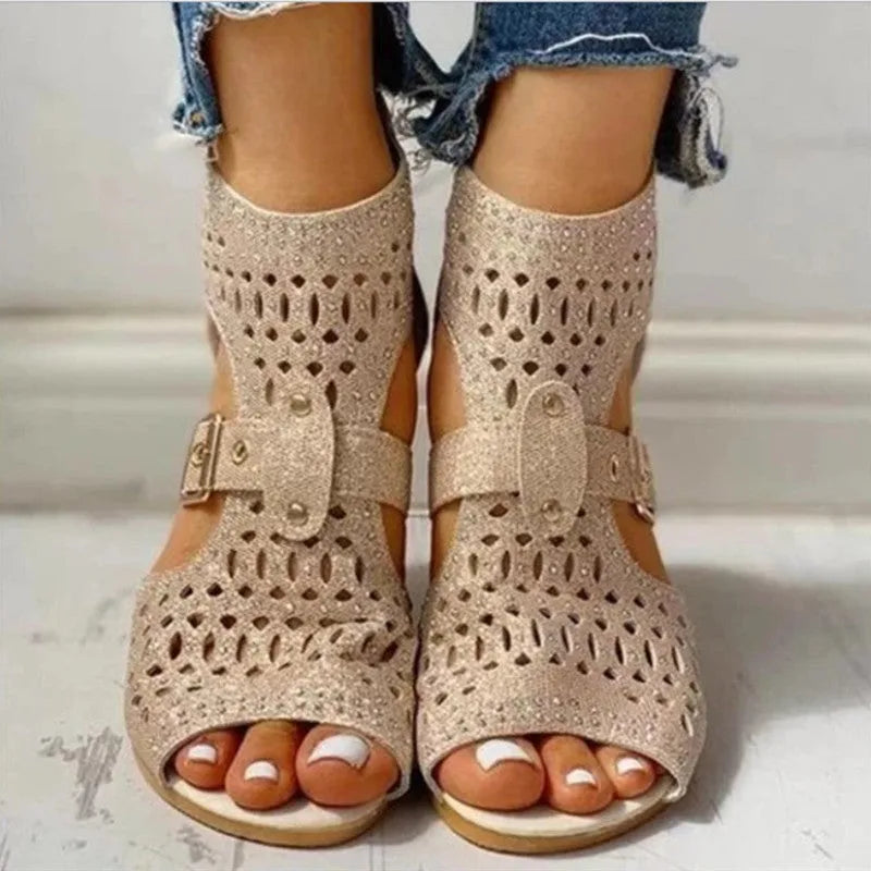 Women's beige flat sandals with a fish mouth toe, back zipper, and a low wedge heel.