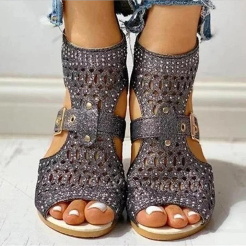 Women's beige flat sandals with a fish mouth toe, back zipper, and a low wedge heel.
