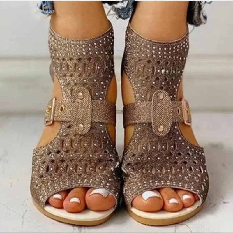 Women's beige flat sandals with a fish mouth toe, back zipper, and a low wedge heel.