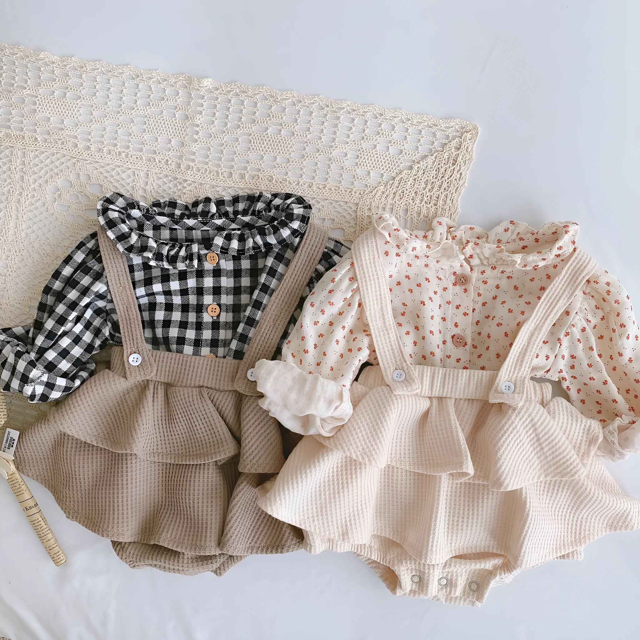 Baby romper with triangle climb style in cotton fabric showing apricot, coffee, floral and check colour options