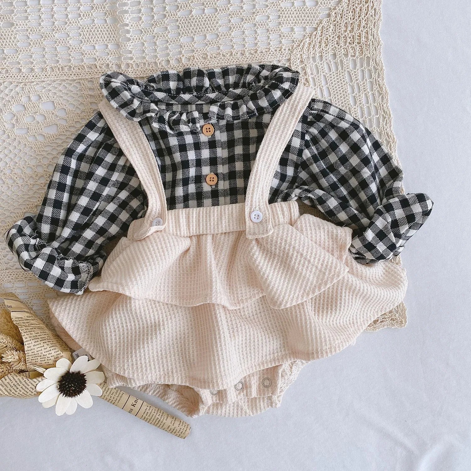 Baby romper with triangle climb style in cotton fabric showing apricot, coffee, floral and check colour options