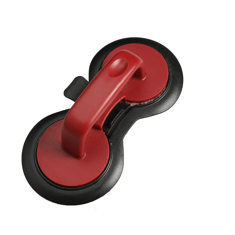 Black and red food-grade ABS plastic burger press mould on a kitchen counter.