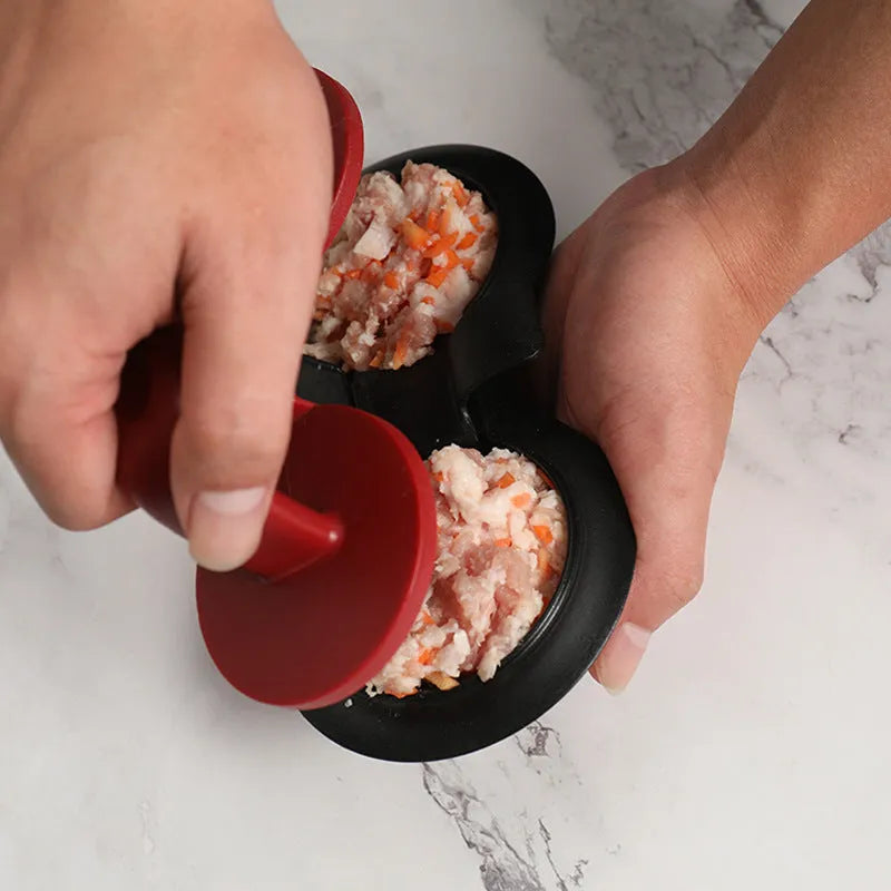 Black and red food-grade ABS plastic burger press mould on a kitchen counter.