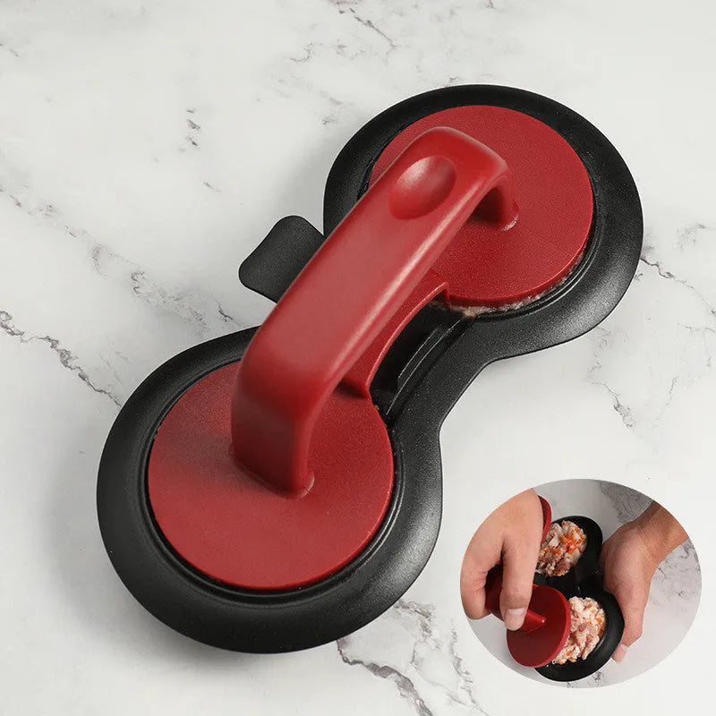 Black and red food-grade ABS plastic burger press mould on a kitchen counter.